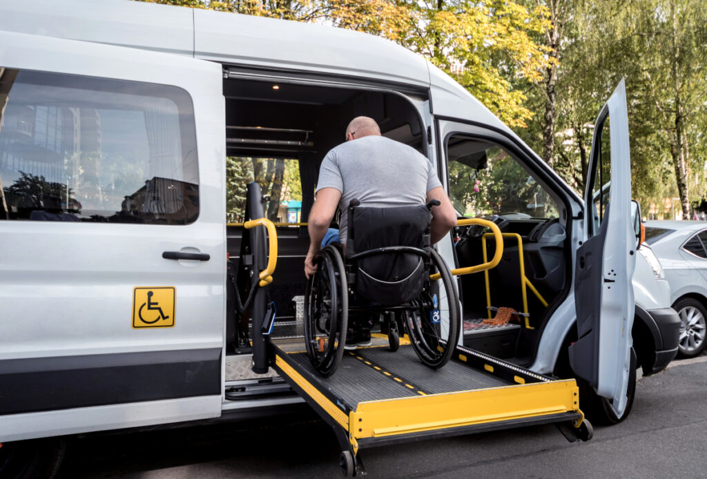 a man in a wheel chair getting in a van using a wheel chair lift